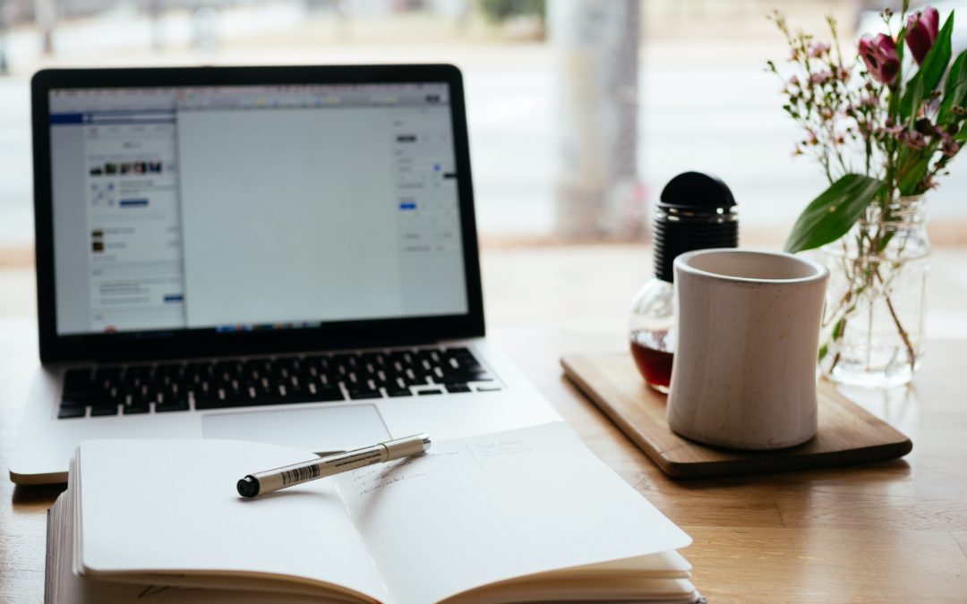 Computer screen and journal with a pen